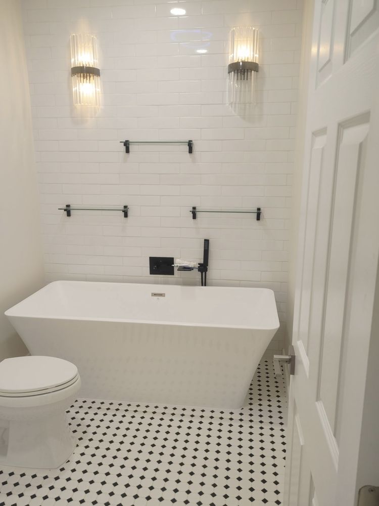 Bathroom with freestanding tub and subway tile by SummitForge Construction