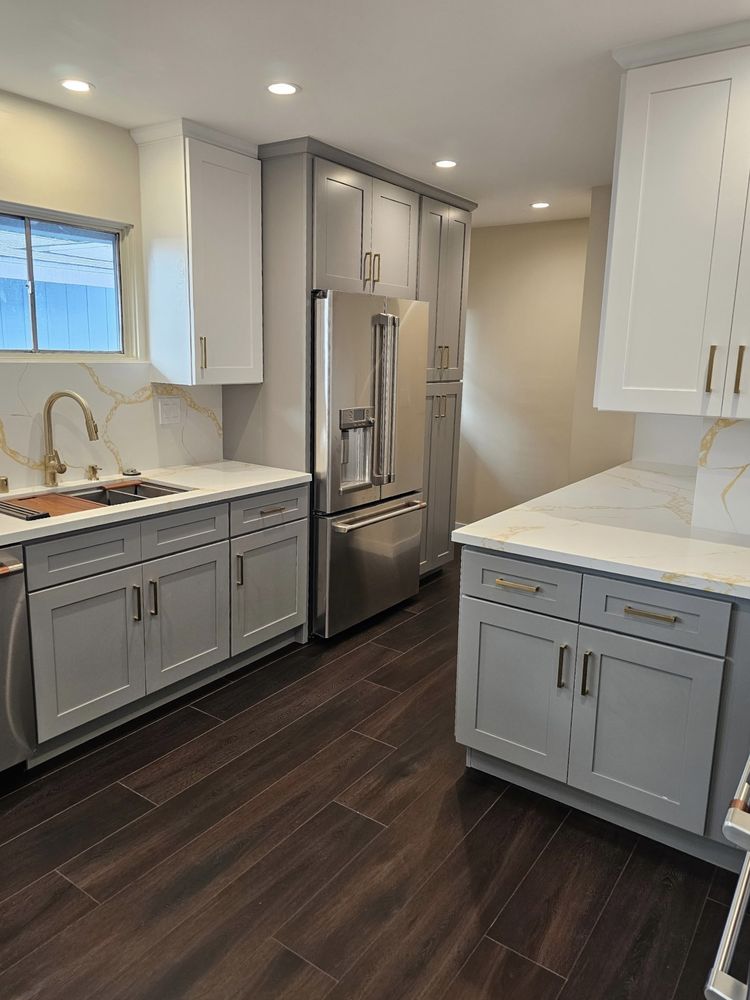 Kitchen remodel with gray cabinetry and quartz counters by SummitForge Construction