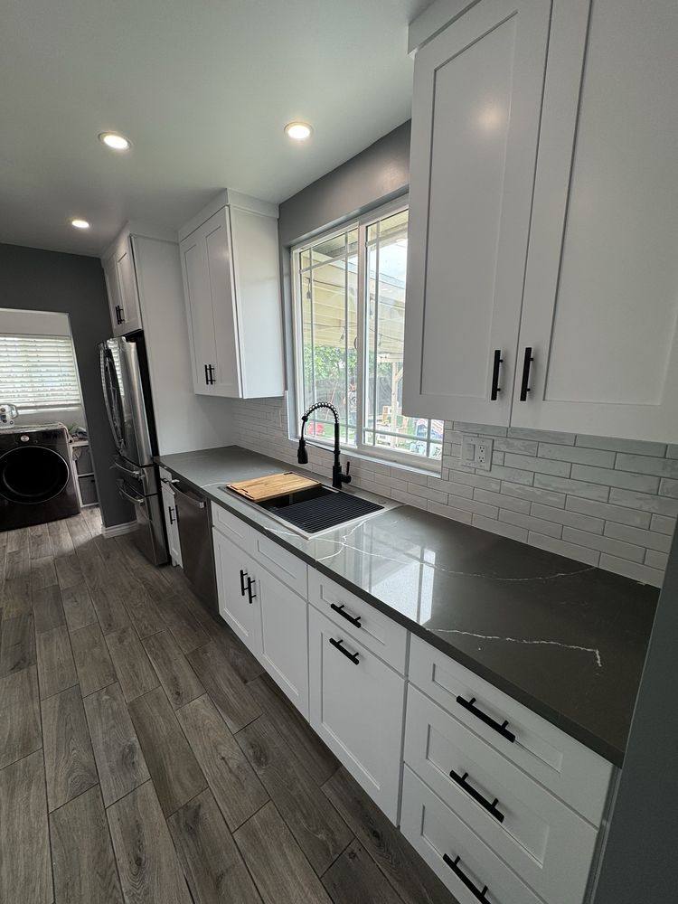 Kitchen remodel with white cabinetry by SummitForge Construction