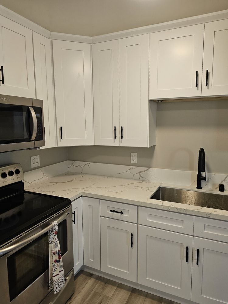 Kitchen remodel with white cabinetry and quartz by SummitForge Construction